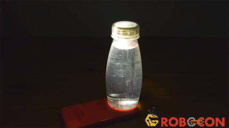 Chỉ cần bật đèn smartphone và đặt chai nước lên trên, thế là bạn có một cái đèn rồi.
