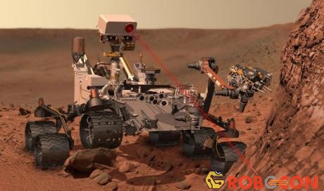 Robot Cusiosity khoan xuống bề mặt sao Hỏa để lấy mẫu vật.