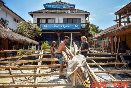Người nước ngoài dọn dẹp cửa hàng đổ nát trên đảo Gili Trawangan. 